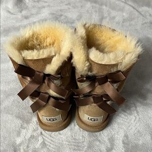 UGG Kids Tan Shearling Boots with Brown Bows